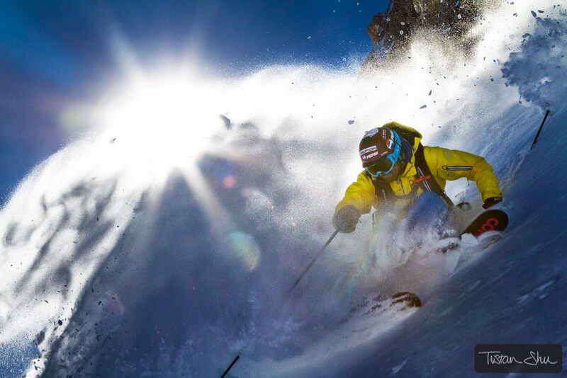 Skier making a turn with snow spraying