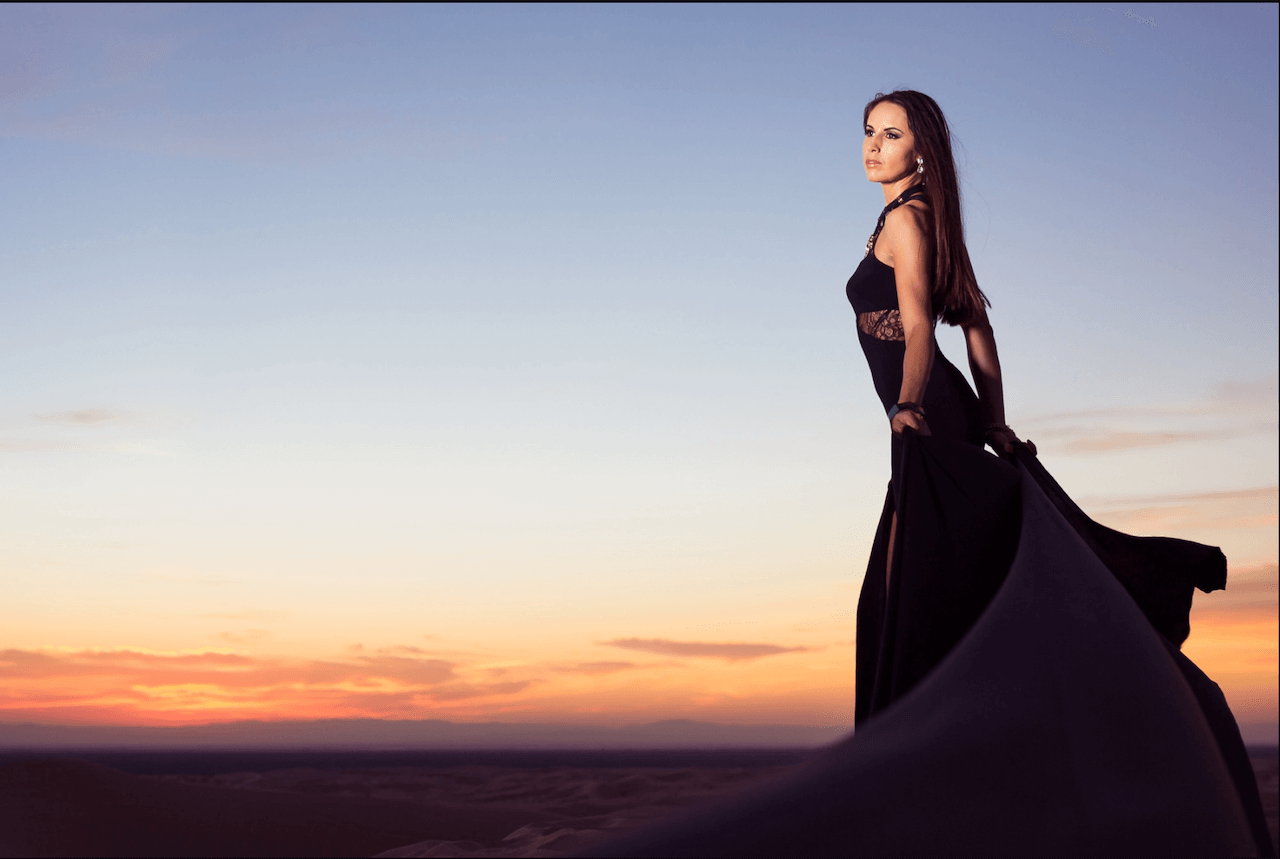 woman stands above horizon