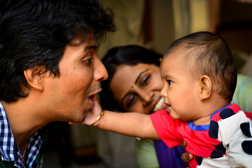 Harsha K R - parents playing with baby